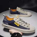 A pair of men's casual canvas lace-up shoes with a round toe and rubber sole.