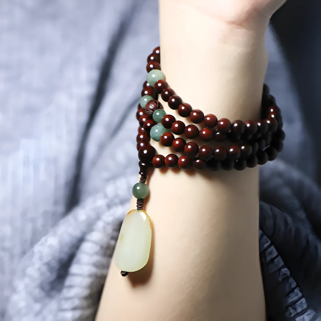 Rosewood bead bracelet with a carved wooden pendant, shown in Indian and Zambia rosewood colour options.