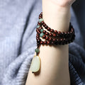Rosewood bead bracelet with a carved wooden pendant, shown in Indian and Zambia rosewood colour options.