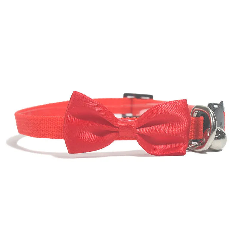 Adjustable nylon cat collar with decorative bow and bell in striped cartoon pattern, multiple colour options shown