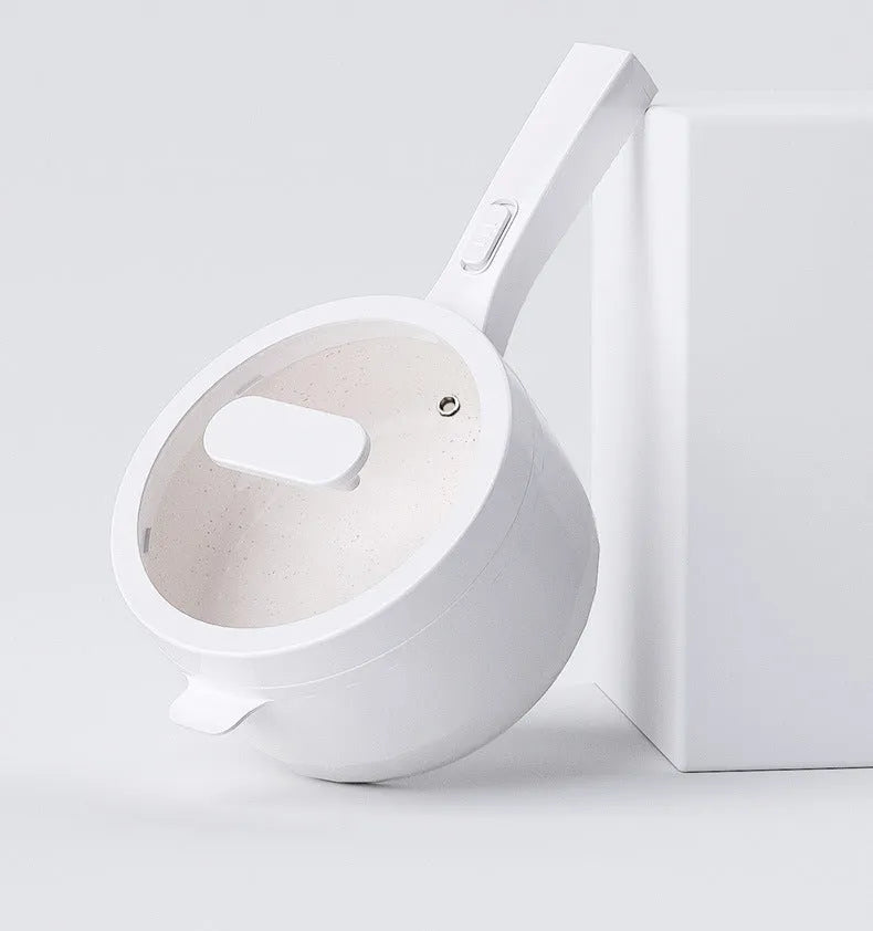 White electric cooking pot with 20cm mouth, 7cm depth, 700W mechanical control, on a dormitory desk