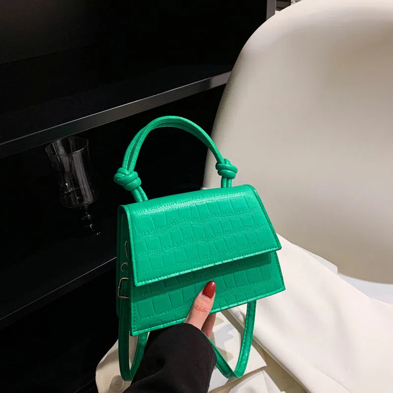 Women's soft PU underarm bag in horizontal rectangle shape with stitched seams and single shoulder strap