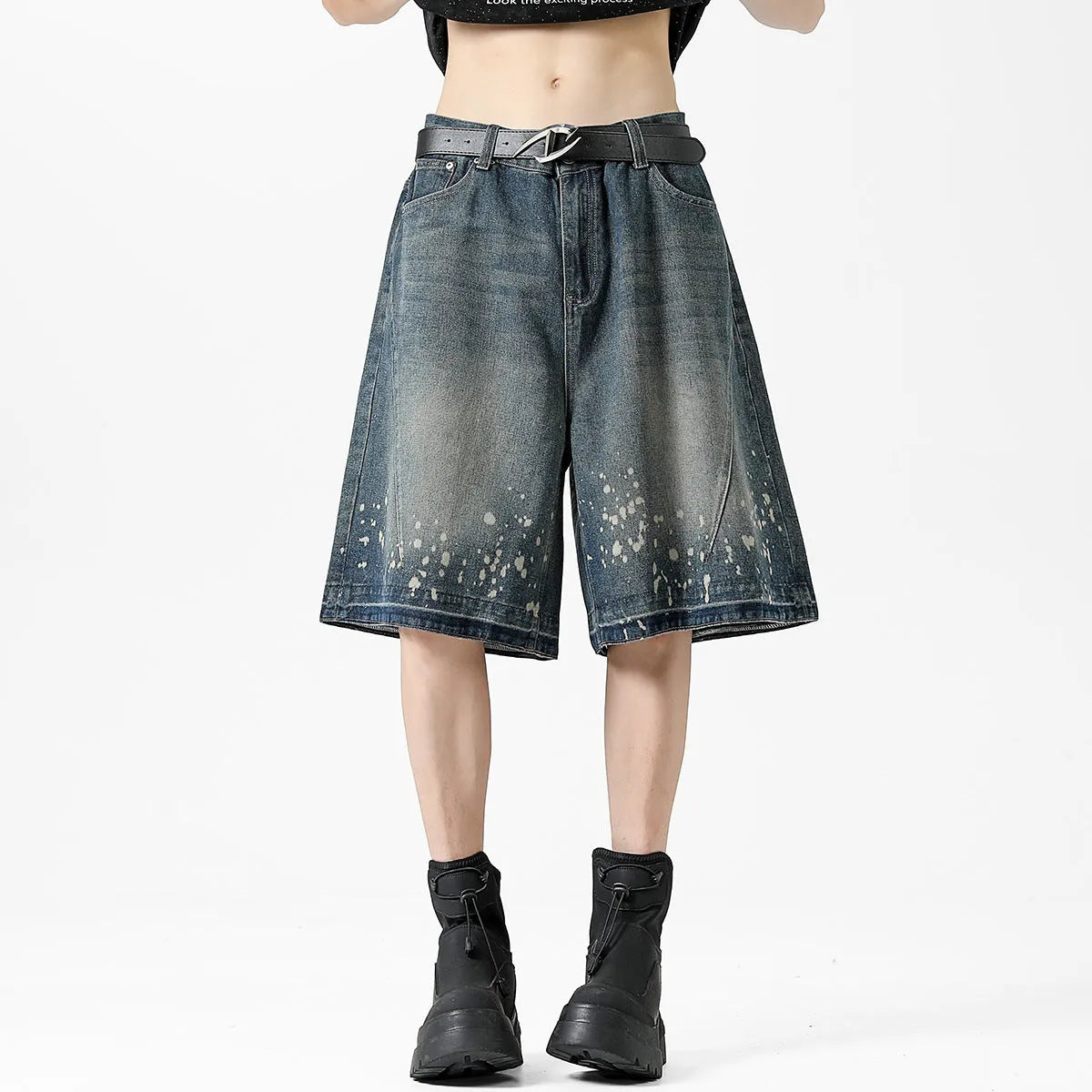 Retro blue washed denim shorts for men with a splash ink pattern and ripped detailing on the legs.