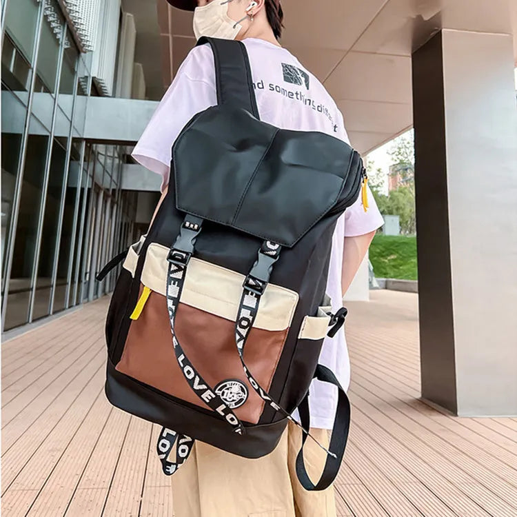 Oxford cloth backpack in black, green, or red with shoulder straps and handle