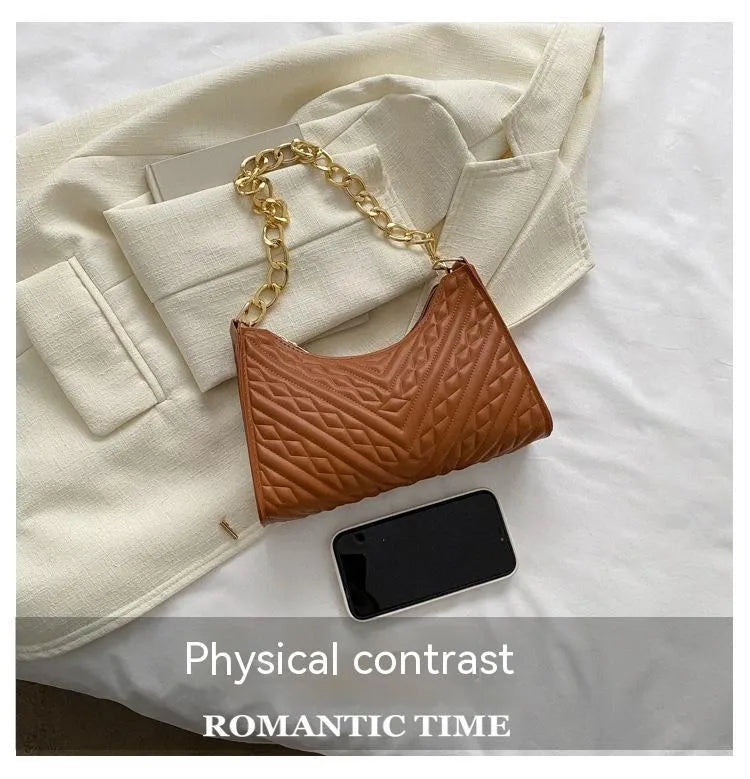 Brown pleated chain shoulder bag with soft handle and adjustable strap showing sewing line detailing