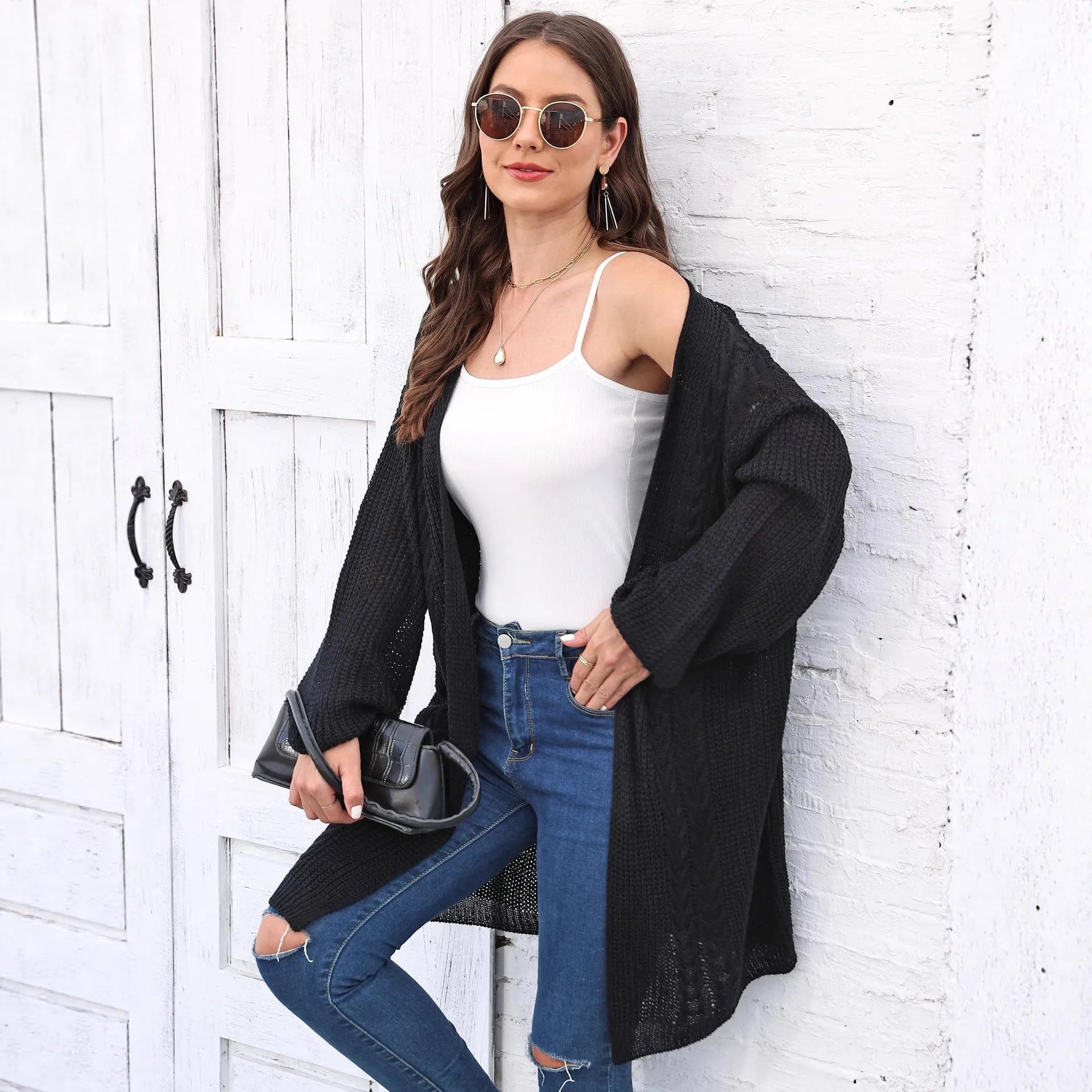 Loose-fitting women's acrylic sweater coat in a solid colour, shown on a model.