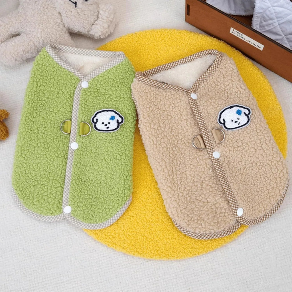 Green coral fleece dog vest with leash ring on a small dog, showing winter outfit.