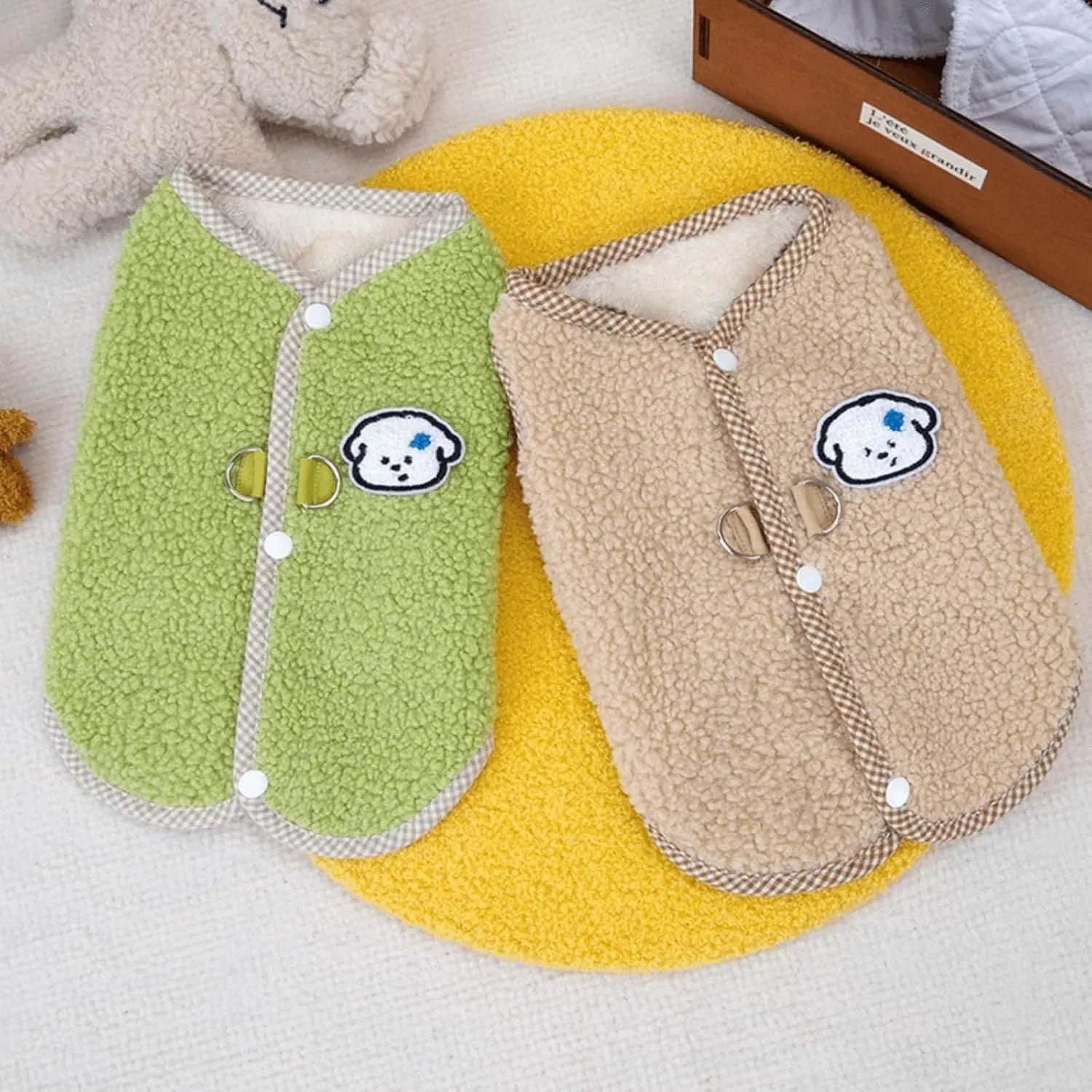 Green coral fleece dog vest with leash ring on a small dog, showing winter outfit.