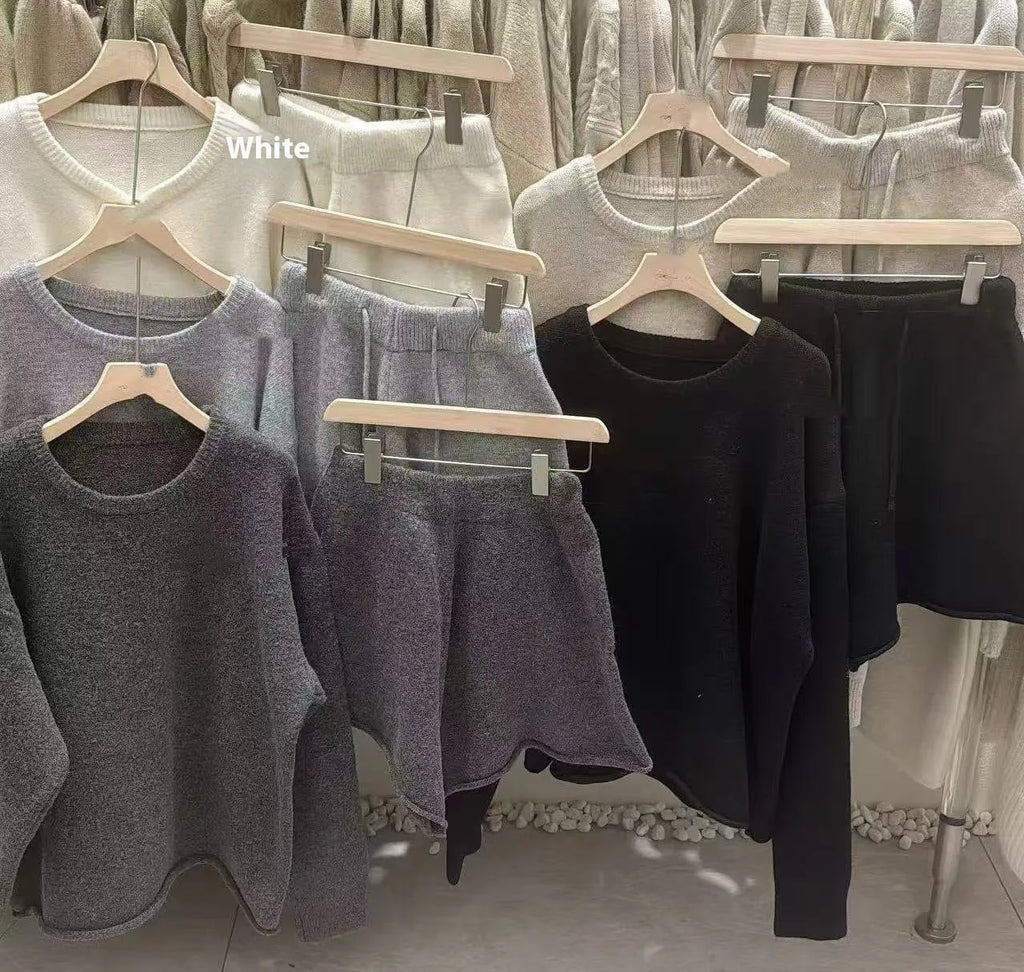 Women's knitted two-piece set showing loose-fitting long sleeve sweater and matching wide-leg shorts in neutral colour