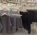 Women's knitted two-piece set showing loose-fitting long sleeve sweater and matching wide-leg shorts in neutral colour