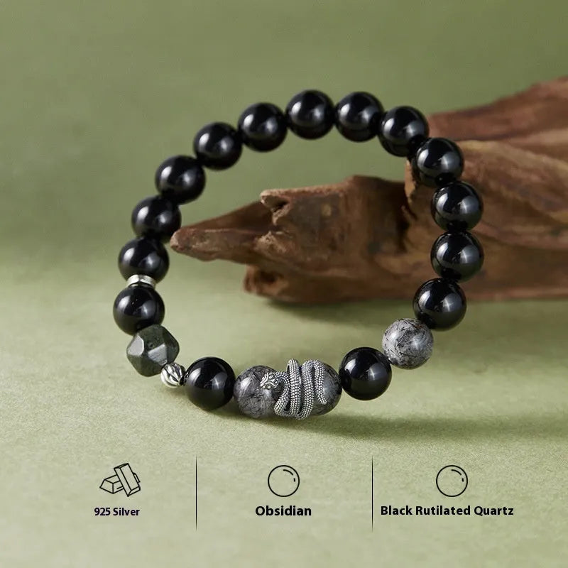 Men's black obsidian and sterling silver snake bracelet with retro design on a wrist.