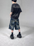 Blue cotton men's denim shorts with frayed hem and embroidered star, loose fit style.