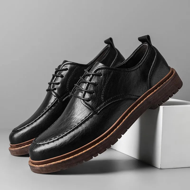 Men's black and brown low top casual leather shoes with round toe and rubber sole.