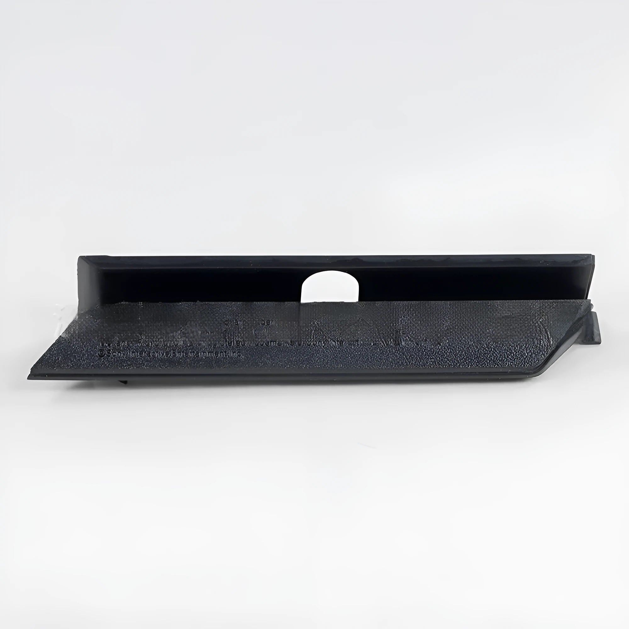 A black plastic hard drive bay cover for a computer case.