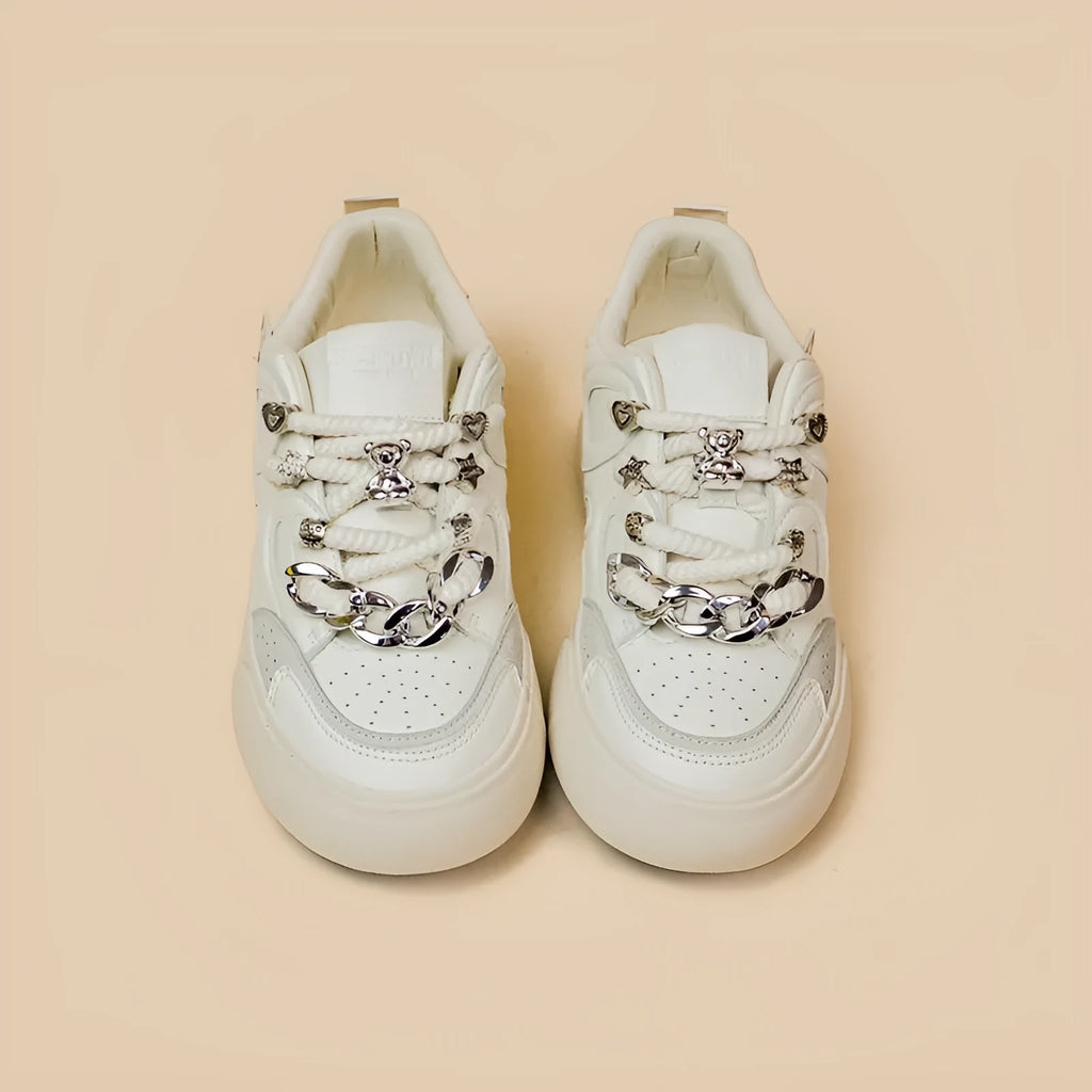Casual women's white low-top sneakers with rubber sole and lace-up closure on a neutral background