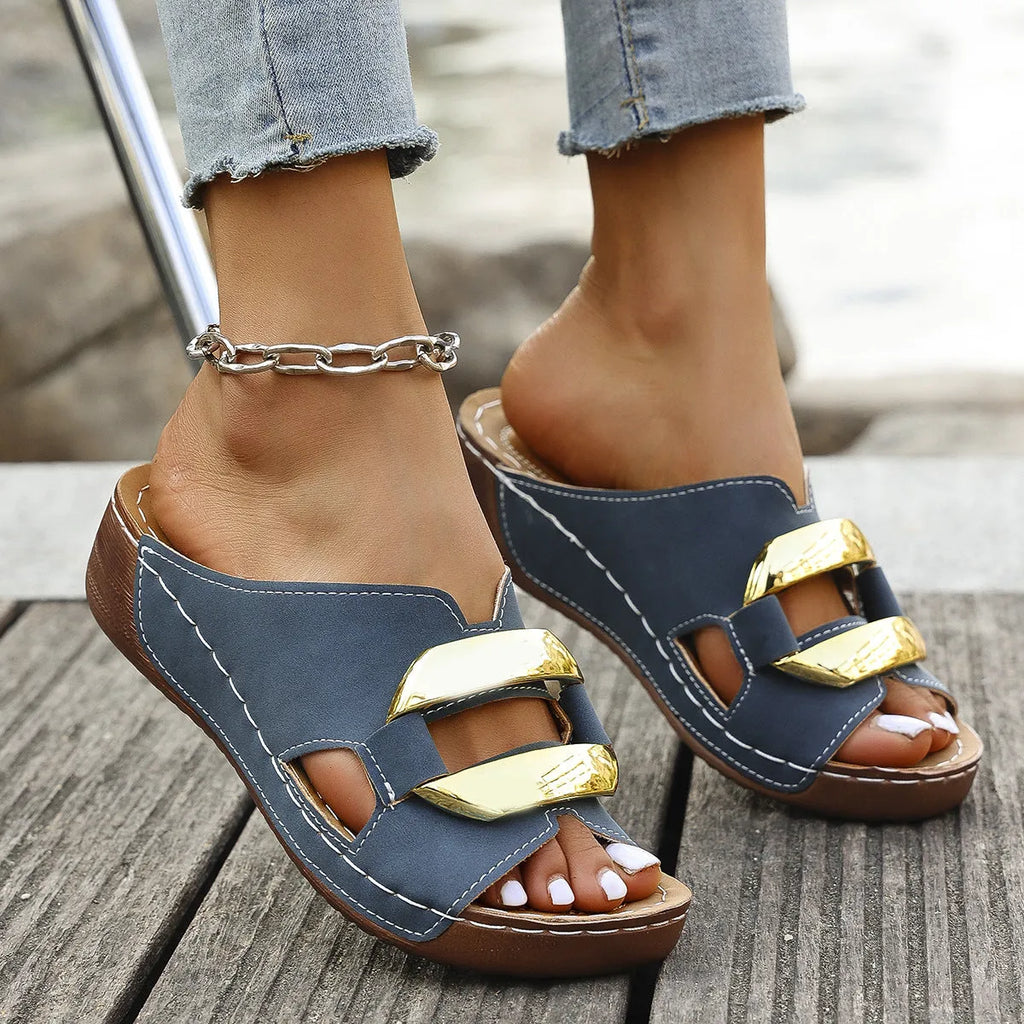 Roman style platform flip-flops in black with metal accents and rubber sole.