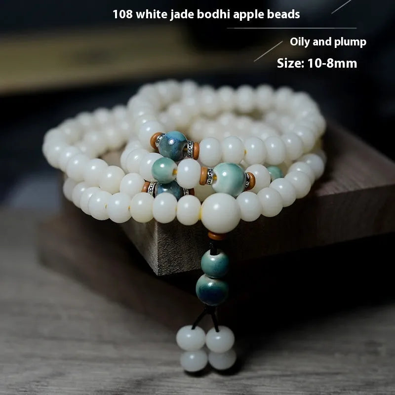 White jade bodhi seed bracelet with 108 flat round beads in two sizes on wrist