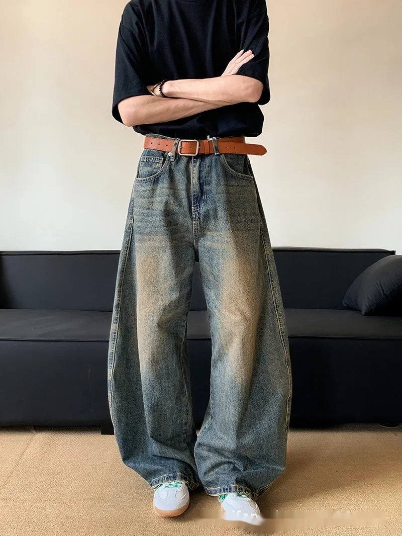Men's retro blue distressed wide-leg jeans with micro-elastic cotton blend fabric showing distressed detailing