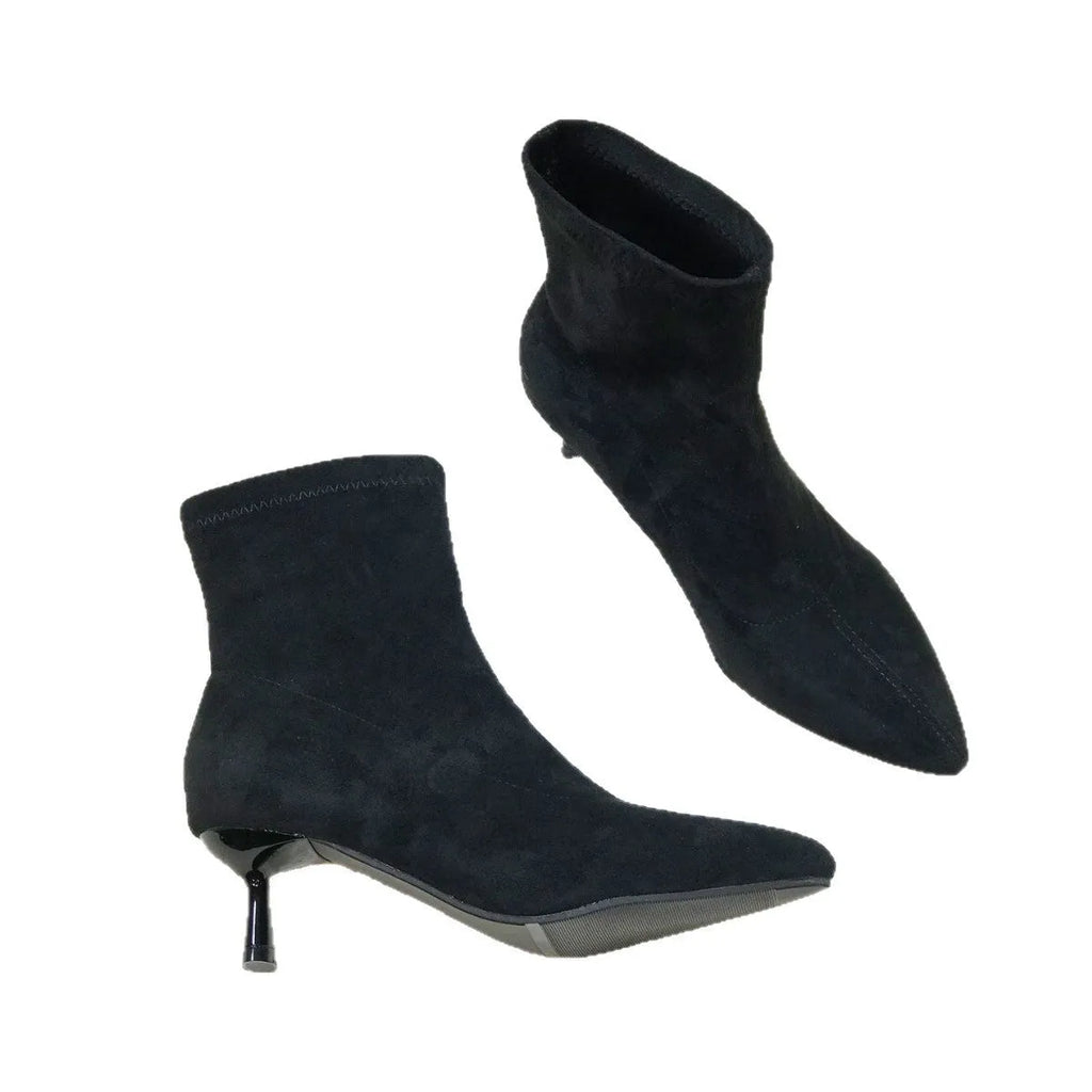 Women's black pointed-toe ankle boots with a stiletto heel and mid-calf sock length.