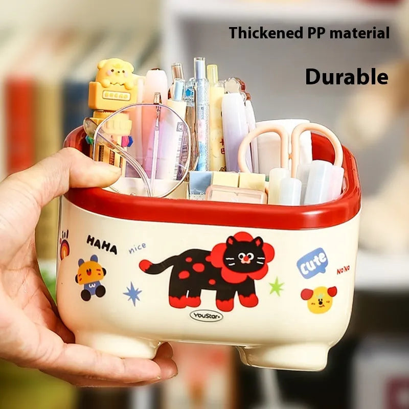 Cartoon-style plastic desktop organiser with various red and brown storage boxes and a pen holder.