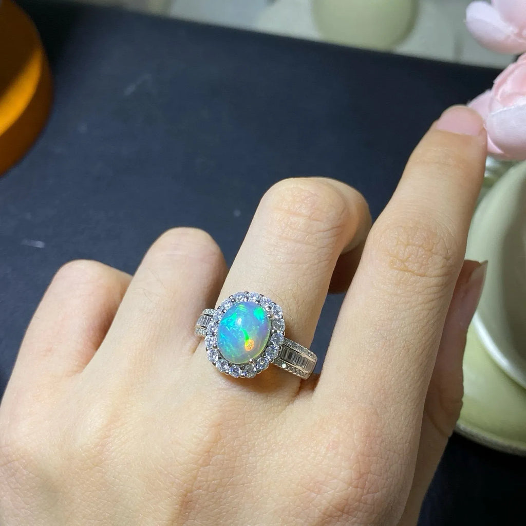 Handmade adjustable silver ring with a natural opal stone in rose gold plating.