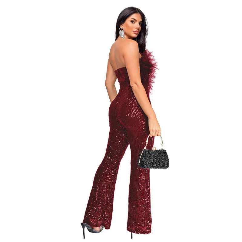 Women's black sleeveless backless jumpsuit with flared legs and sequin details on a mannequin.