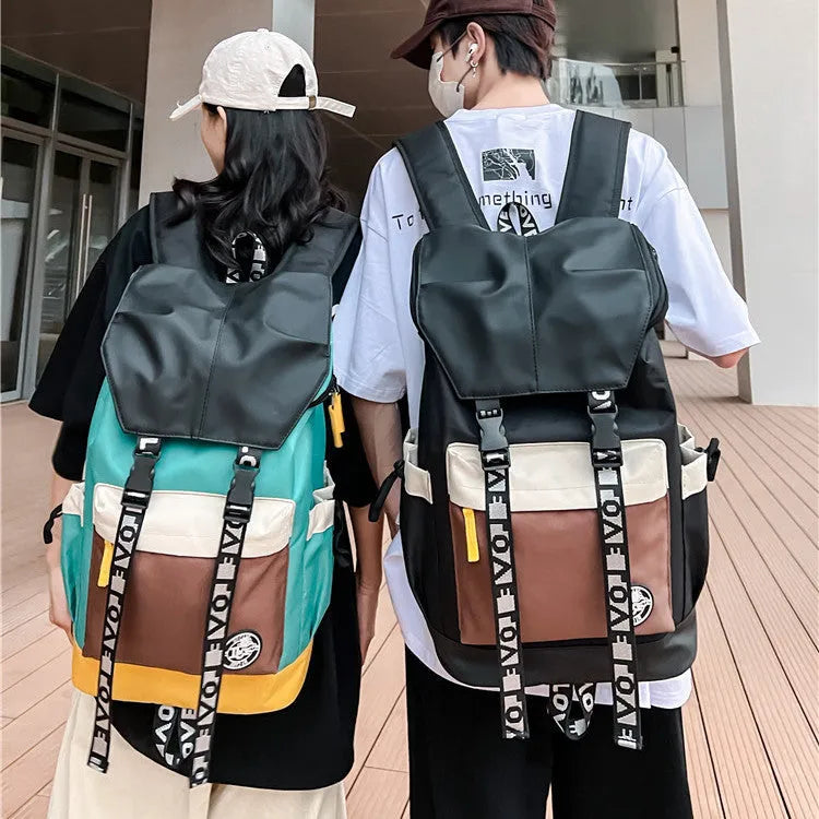 Oxford cloth backpack in black, green, or red with shoulder straps and handle