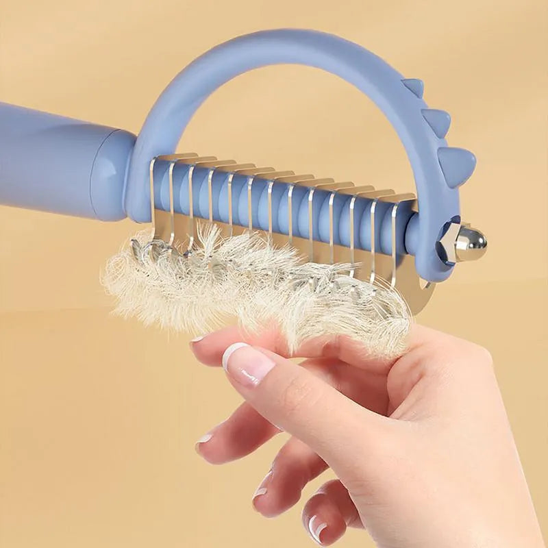 Blue dinosaur-shaped double-sided self-cleaning cat brush for grooming.