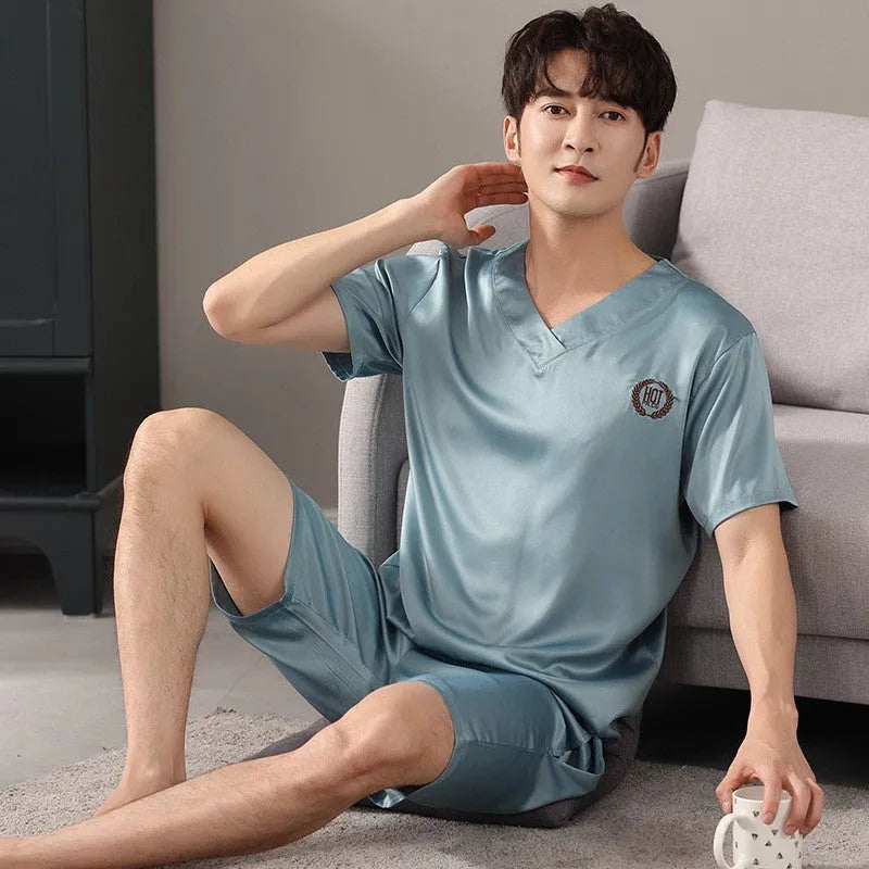 Man wearing a light blue ice silk short-sleeve pajama shirt and matching loose shorts.