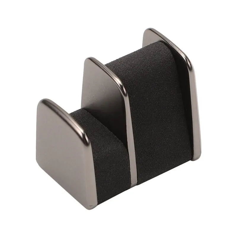 Zinc alloy and leather car dashboard clip for holding sunglasses, shown in green.