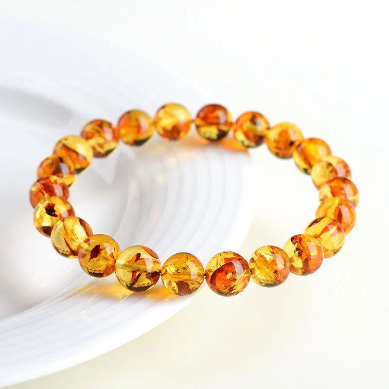 Natural yellow piebald amber bracelet with flower spot patterns and polished geometry beads