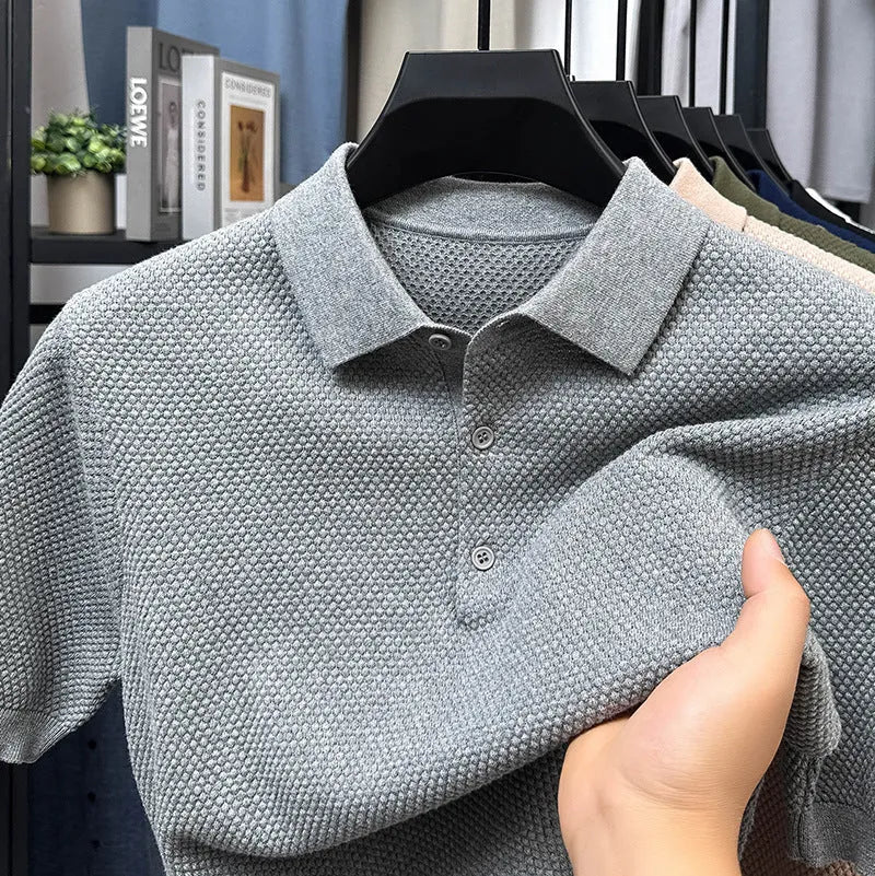 Man wearing a loose fit grey cotton short sleeve sweater, casual pullover style