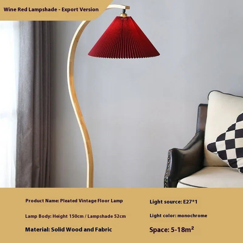 Vertical retro table lamp with a choice of log white or wine red lampshade on a wooden surface.