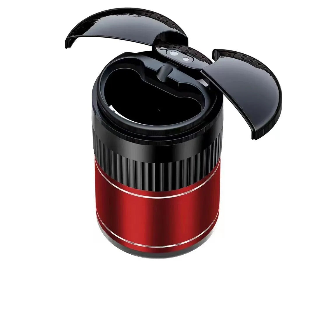 Smart black metal car ashtray with lid, showing compact size next to a charging cable.
