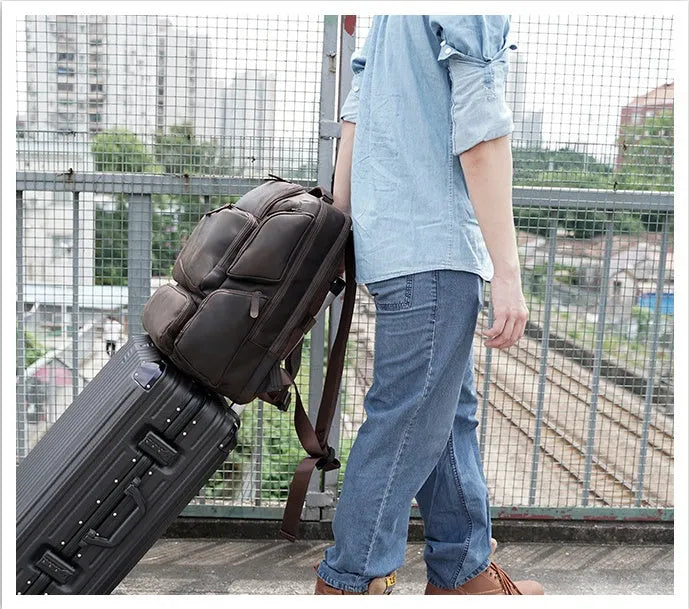 Dark brown retro genuine leather backpack for men showing front view with double straps and soft handle.