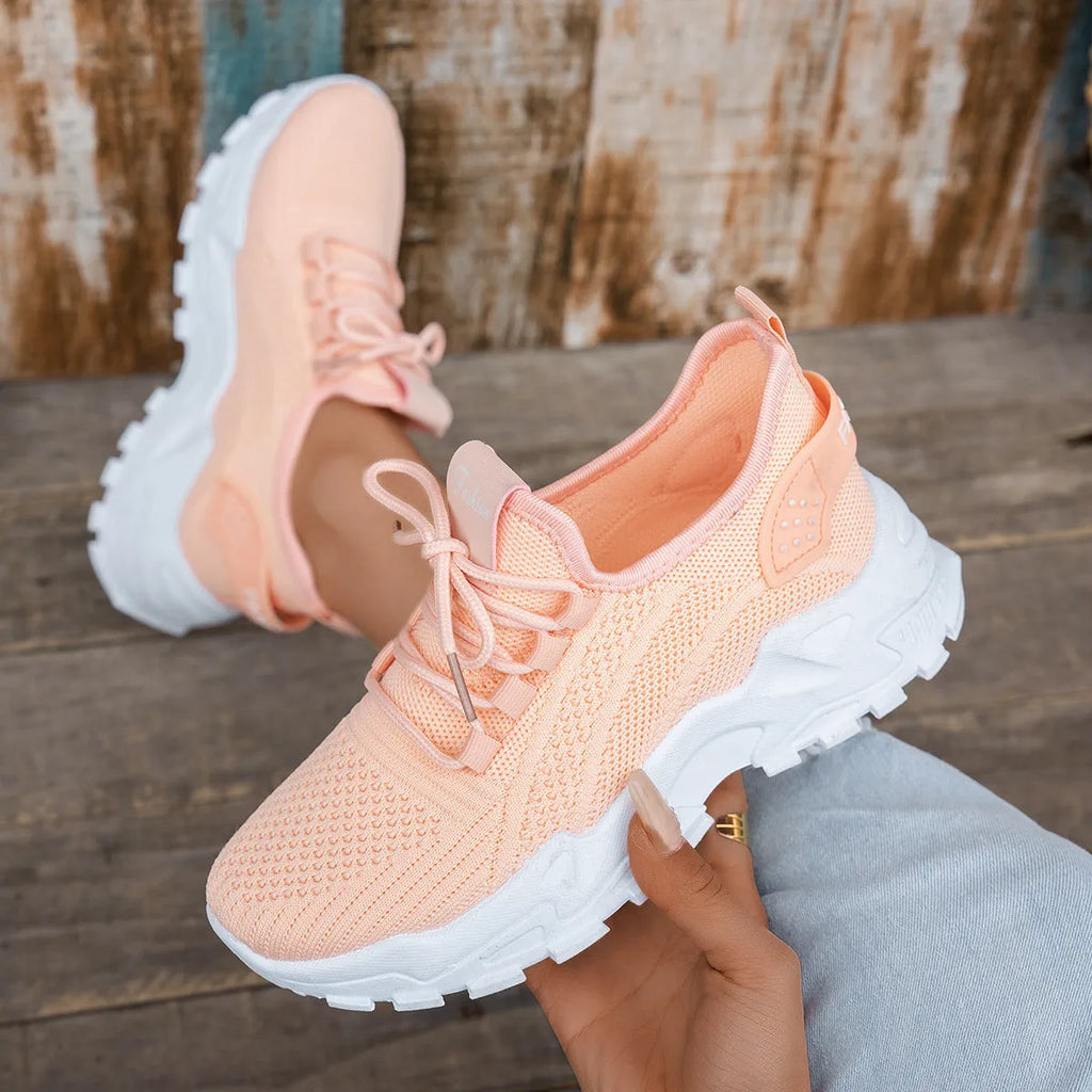 Women's Flyknit mesh casual sports shoes in various colours with flat heel and lace-up front.