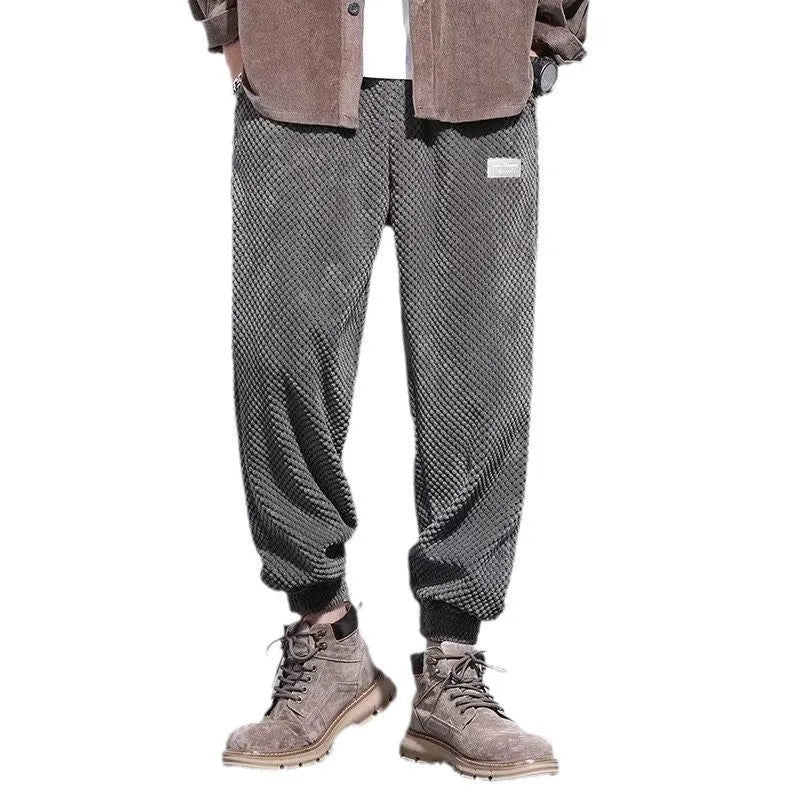 Men's grey ankle-tie sweatpants with a straight leg on a plain background