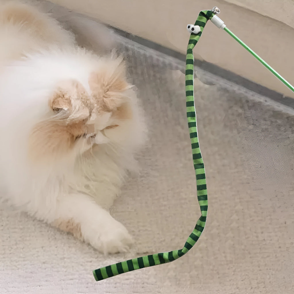 Cat wand toy with a polycarbonate pole and a long colourful plush strip with a bell, held in a person's hand.