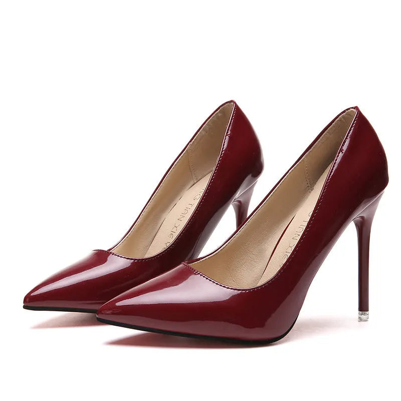 Women's nude stiletto heel pointed toe high heel pump in apricot colour with a buckle.