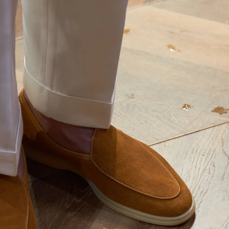 Men's handmade brown leather loafers with a TPR beef tendon sole on a white background.