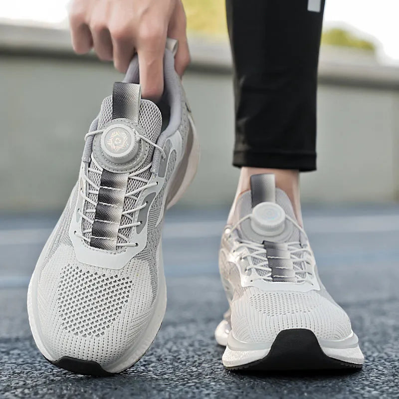Men's white rotating button running shoes with mesh upper and buckle closure on a solid background.