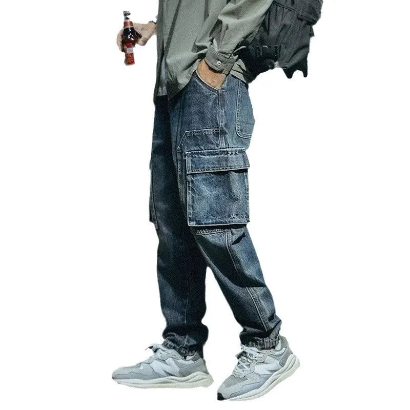 Men's blue loose straight-leg denim trousers with a zip fly placket laid flat.