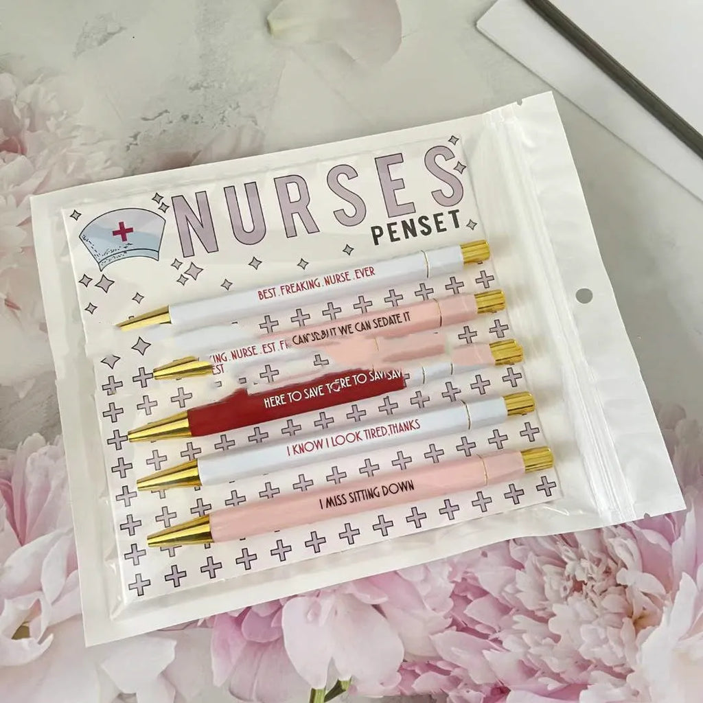 Five blue retractable ballpoint pens with white nurse-themed text, laid side by side.