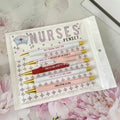 Five blue retractable ballpoint pens with white nurse-themed text, laid side by side.