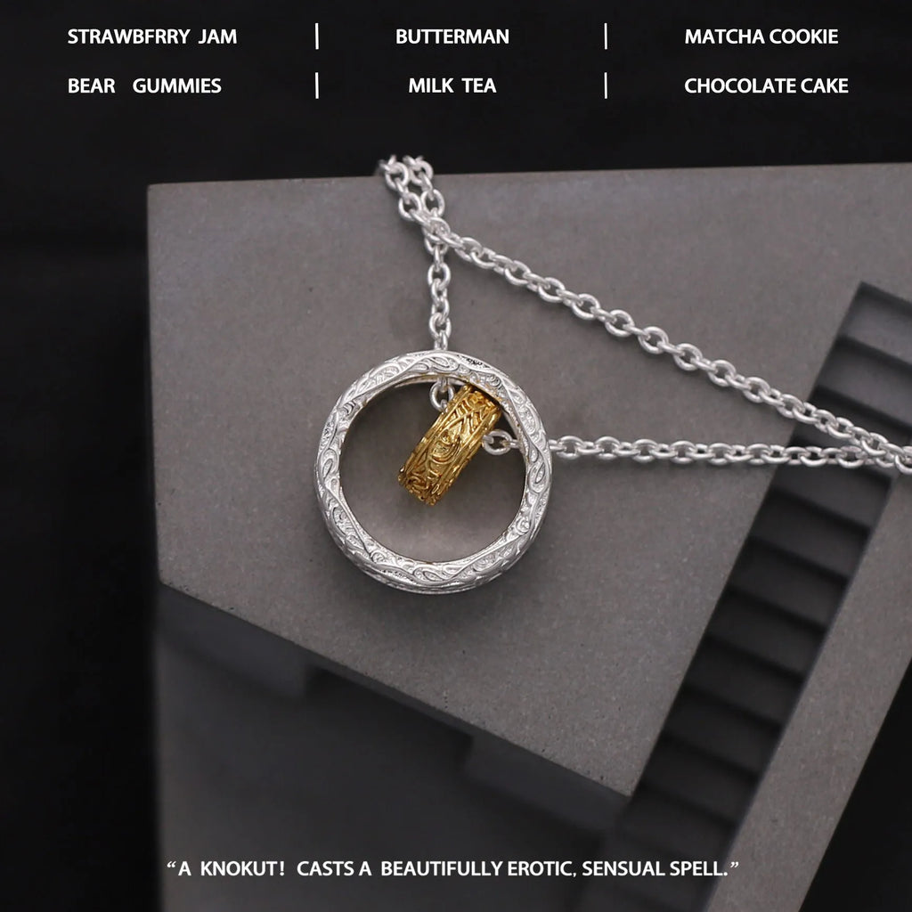 Geometric copper nested necklace with gold and silver electroplated finish, round and ring elements, on display