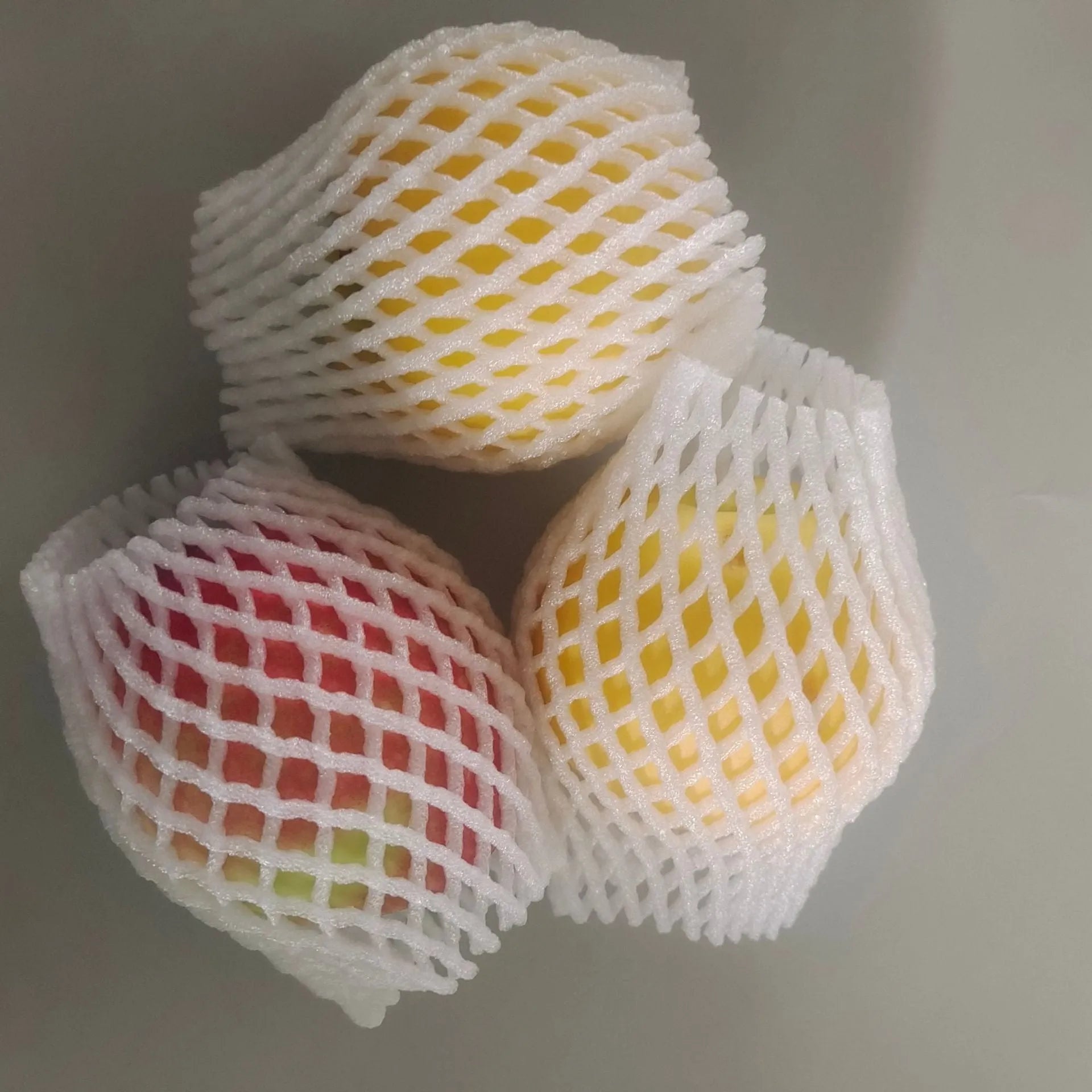 White foam shockproof protective case for colourful fruit showing size options