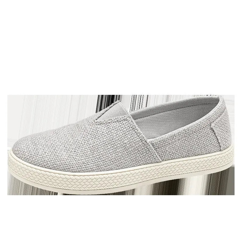 Men's beige canvas slip-on shoes with round toe and PVC sole on a plain background