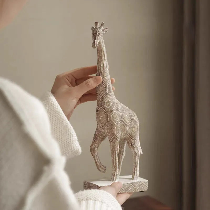 Wood colour European style resin giraffe ornament measuring 30.5 cm tall.