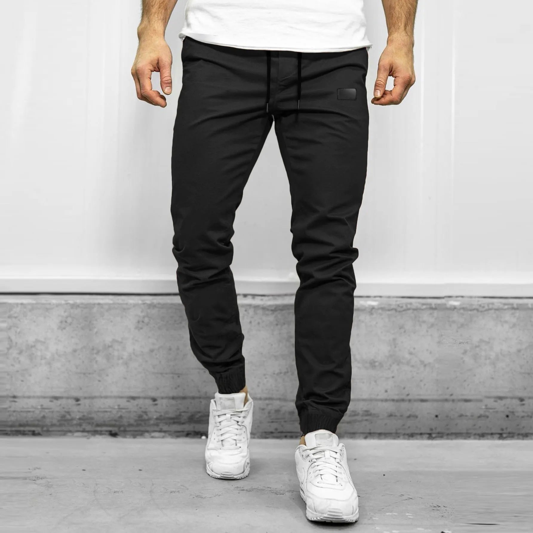 Men's quick-dry loose tapered running trousers in army green, side view on model