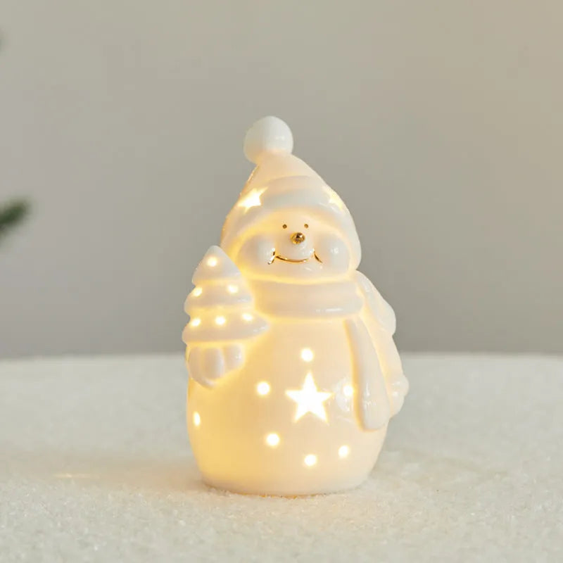 Ceramic Christmas snowman decoration with luminous glow on desktop